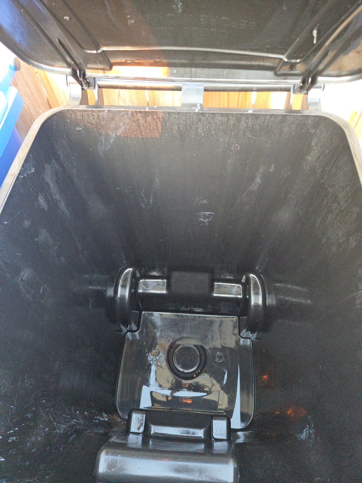 Pure Clean Solutions technician cleaning a residential bin